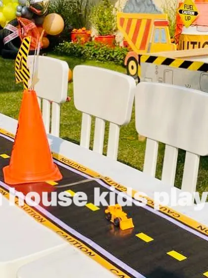 Detailing on the construction-themed table. A road-like table runner with toy trucks and traffic cones makes the kids' dining experience interactive and fun.