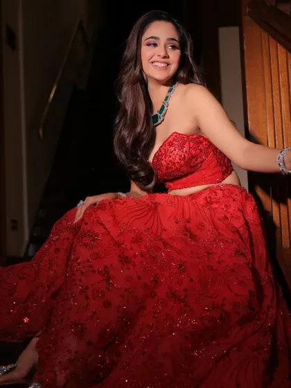 A playful moment in a sparkling red two-piece set. I styled this with a statement emerald necklace for a fun and glamorous cocktail look.
