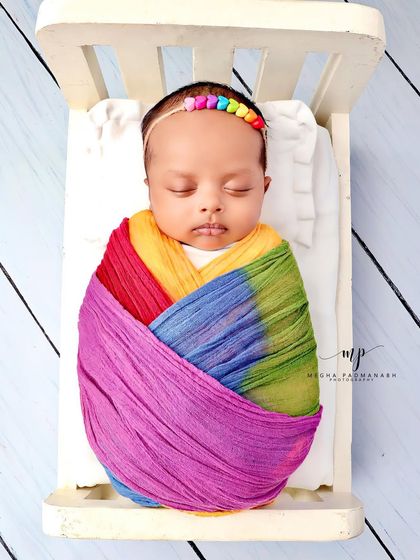 A top-down view of the rainbow bed setup, complete with a rainbow-beaded headband.
