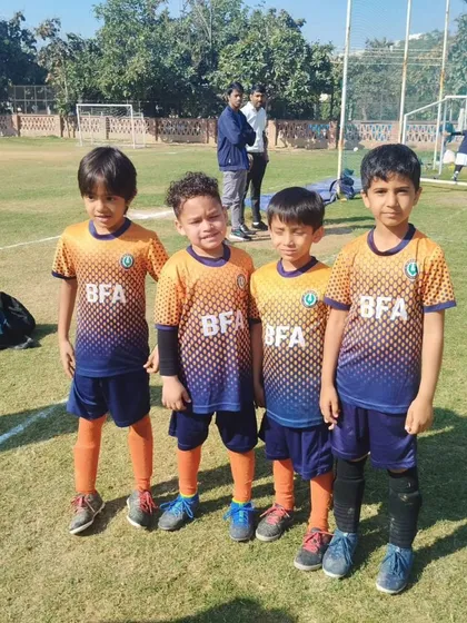 Four members of our Under 7 team, standing together. The friendships they build are as important as the skills they learn.