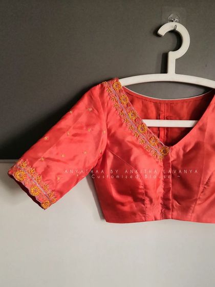 The front view of the custom blouse, showing the V-neck with delicate floral embroidery.