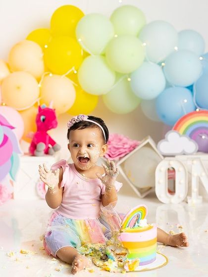 The pure excitement of a first birthday cake smash. Her joyful scream and messy hands say it all in this magical unicorn and rainbow themed shoot.