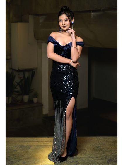 A full-length shot of a model in a stunning sequined evening gown. This type of photo is essential for a model's book to showcase how they carry themselves in formal wear.