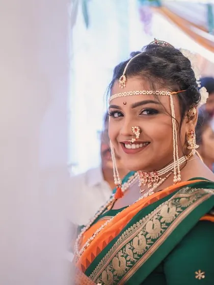 A candid shot of the bride during her wedding ceremony, looking happy and radiant.