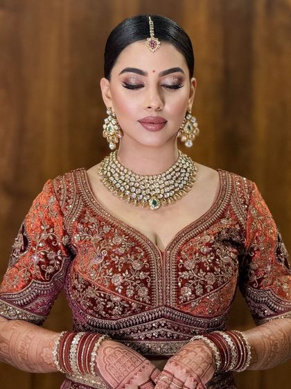 An eyes-closed shot to highlight the soft, blended eyeshadow and the beautiful details of her diamond and emerald jewelry.