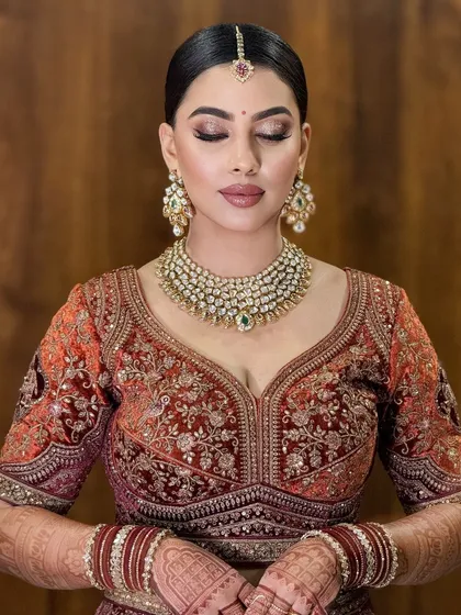 An eyes-closed shot to highlight the soft, blended eyeshadow and the beautiful details of her diamond and emerald jewelry.