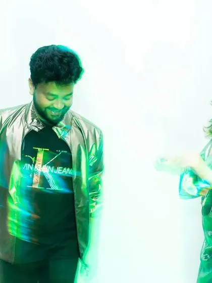 A playful, abstract shot with green and blue light creating a cool, futuristic feel. The motion blur captures their interaction and movement, resulting in a fun and unconventional pre-wedding photo.