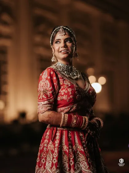 My beautiful bride Anjali, radiating timeless elegance. We went for a flawless nude glow that perfectly complemented her vibrant red lehenga, proving that nude makeup can be just as impactful.