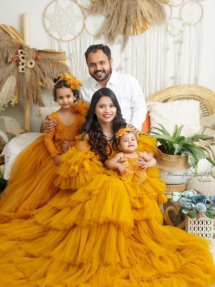 A full-length view of this beautiful family in their coordinated yellow gowns. The boho-chic setting perfectly complements their sunny dispositions.