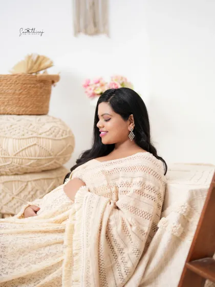 A peaceful portrait of a mother-to-be seated in our boho corner. The soft lighting and natural elements create a calm and serene atmosphere.