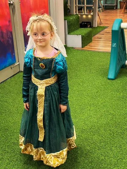 A little girl dressed as Princess Merida from "Brave," looking regal on our green play turf.