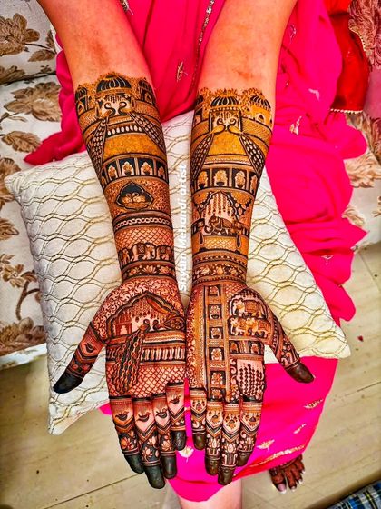 A stunning design featuring palace architecture and peacock motifs, covering both arms completely.