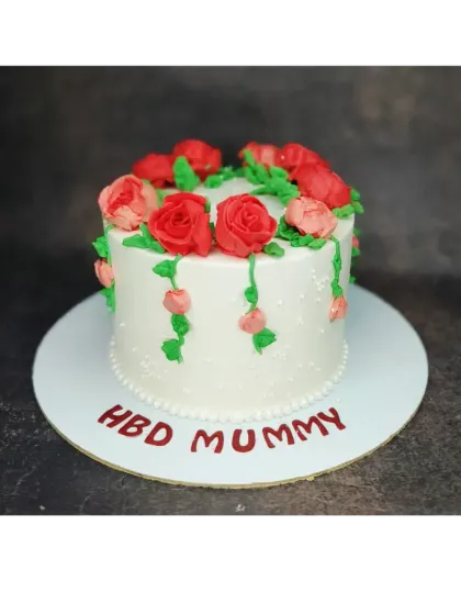 A beautiful floral cake for "Mummy". This fresh pineapple cake is adorned with a cascade of red and pink flowers.