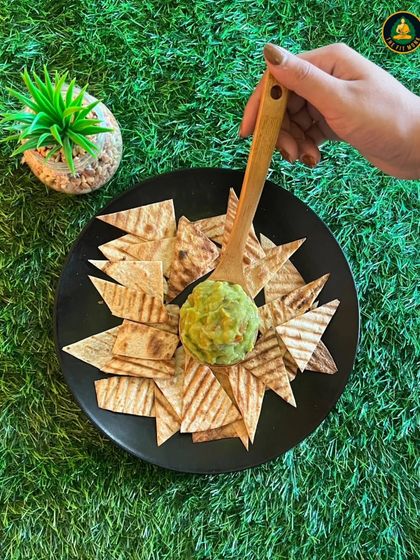 Dip, snack, repeat! My homemade guacamole with baked wheat chips is a healthy and delicious snack that's perfect for satisfying your cravings.