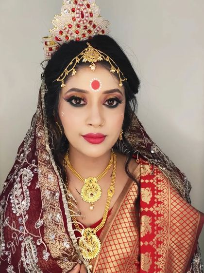 A confident portrait of the Bengali bride, looking radiant and ready for her wedding.