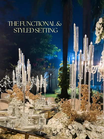 A dinner setting should be more than just functional; it should be an experience. For this reception, I designed a tablescape with tall, modern candelabras, golden accents, and lush white florals on a mirrored table to create a setting of pure, styled elegance.