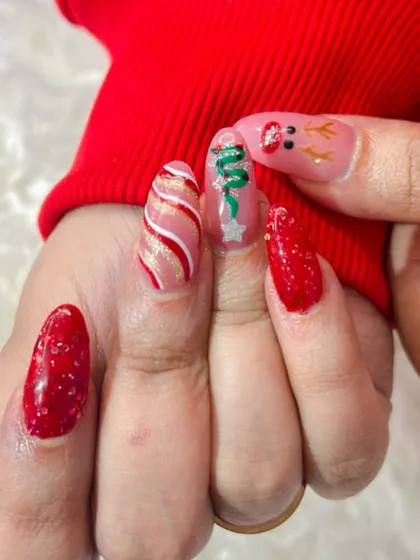 A super cute Christmas set with a reindeer, Christmas tree, and glittery red nails.