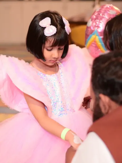 A close-up of the birthday girl in her beautiful pink dress.