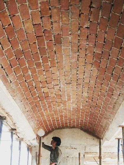 A photo from a site visit, showing the inspection of a newly constructed brick vault ceiling. This hands-on approach is crucial to ensuring quality and realizing the design intent.