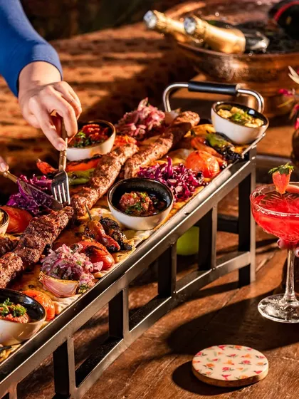 I present to you India's longest kebab, our 1.5-meter Adana Kebab. It’s more than a dish; it’s a spectacle of authentic Turkish grilling, meant for sharing and creating a truly dramatic dining moment.