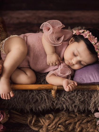 Sleeping soundly in a tiny bed surrounded by flowers. I use a variety of props to create beautiful and safe settings for my newborn photoshoots.