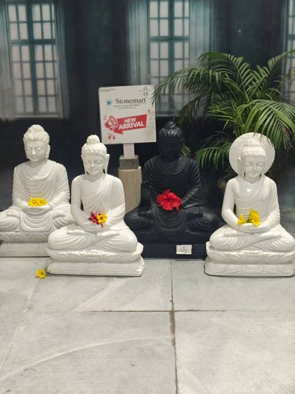This image displays our range of 2-foot Buddha idols, including a white marble Buddha with a halo, showcasing the different carving styles available.