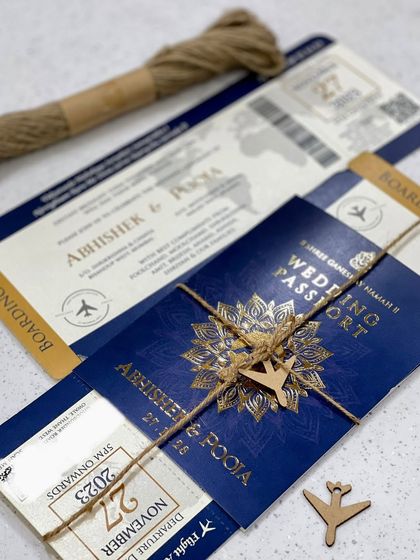 A passport invitation perfect for a destination wedding. This design features a boarding pass-style insert and is tied with jute rope and a small wooden airplane for a charming, travel-themed touch.