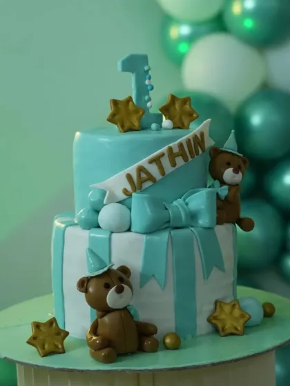A matching themed cake for Jathin's first birthday. I can coordinate with your baker to ensure the cake complements the decorations.