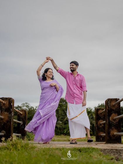 A joyful dance on the bridge. Capturing movement and laughter is key to my candid photography style.