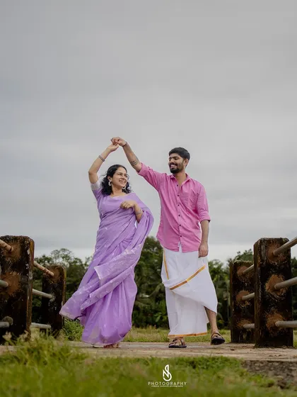 A joyful dance on the bridge. Capturing movement and laughter is key to my candid photography style.