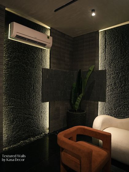 Here, I used heavily textured stone panels to create a dramatic corner. The integrated strip lighting emphasizes the raw, rugged finish of the stone, creating a powerful contrast with the smooth, modern furniture.