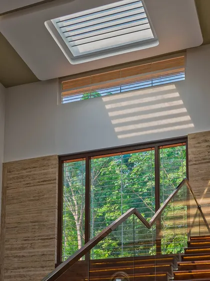 A detail from a residential project in Mangalore, showcasing the interplay of light and structure. A carefully placed skylight casts dynamic shadows across the staircase, demonstrating our focus on how light moves through a space during the day.