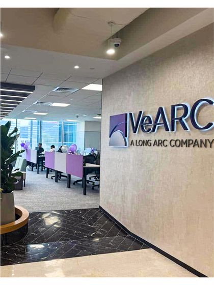 The entrance to the VeArc office, showcasing the brand logo against a textured wall. This image represents our work in commercial spaces where branding and biophilic design are seamlessly integrated.