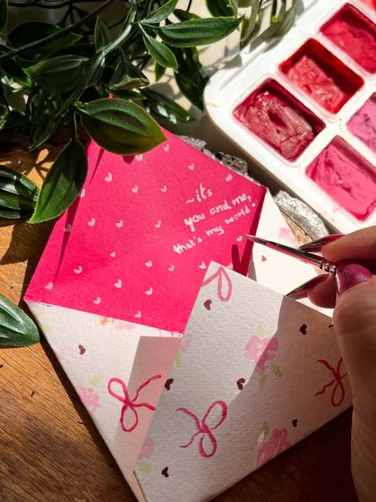 Adding the handwritten note inside the finished custom envelope. It's all about the details.