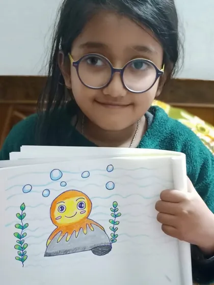 Another proud student showing off her colorful octopus. It's so rewarding to see children gain confidence as they master new drawing techniques.