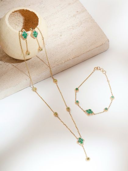 The Green Meadow set, a nature-inspired dream in yellow gold. This image shows the lariat necklace, bracelet, and drop earrings together.