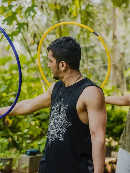 Here I am giving some pointers during a hoop workshop. I work with each person to help them get comfortable with the prop, whether it's learning a new trick or just getting the hoop to spin.