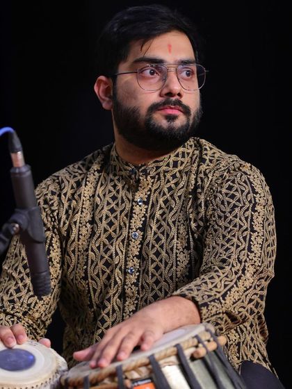 A portrait taken during a live concert, with the stage lighting creating a dramatic effect.