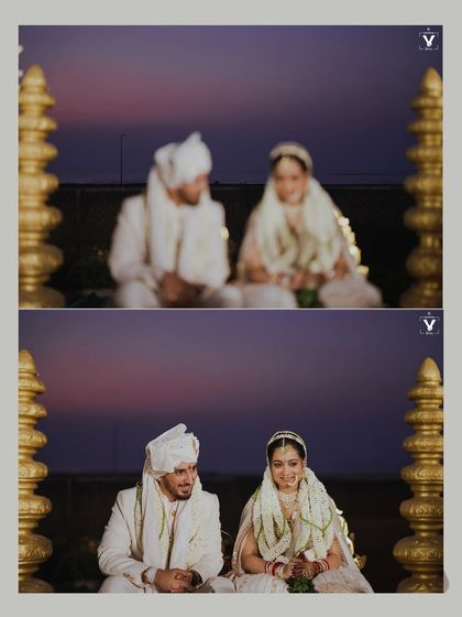 A beautiful shot of the couple seated at the mandap against a magical twilight sky. The focus shifting from blurry to sharp captures the feeling of a dream becoming reality.
