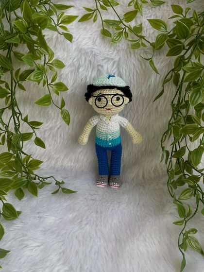 This handsome little boy replica doll features curly hair, a cap, and removable glasses. It’s so fun to create these little details that make each doll a true mini-me.