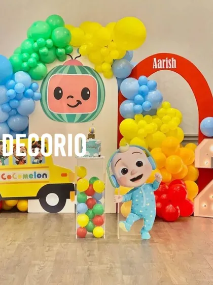 A bright and cheerful Cocomelon theme party, one of my most popular requests for toddlers. This setup includes character cutouts of JJ and the iconic yellow bus, a colorful balloon arch, and a Cocomelon-head backdrop, creating an immersive experience for the little ones.