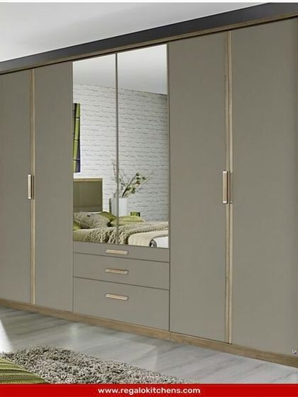 A classic wardrobe design with a large central mirror and integrated drawers. The neutral grey finish and simple hardware make it a versatile choice for any bedroom.