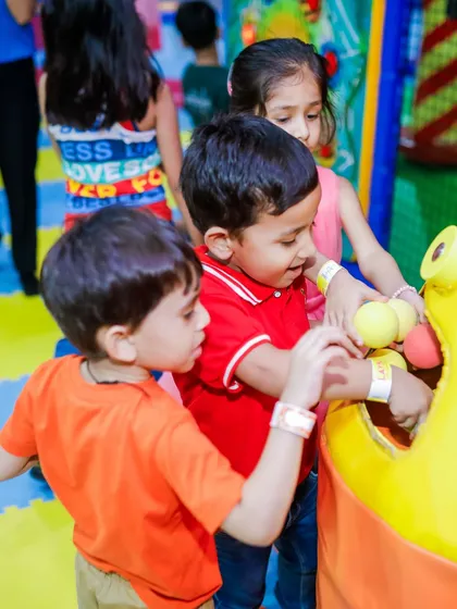 Teamwork makes the dream work! Kids collaborate to feed balls into one of our interactive play features during a fun-filled birthday bash.