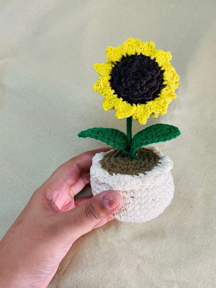 Another angle of the crochet sunflower pot, showing the texture of the hand-stitched petals and leaves. Each one is made with love and attention to detail.