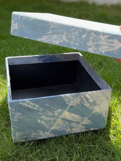 The lid of the indigo box, showing the intricate, abstract pattern created by the dyeing process. Each box is completely unique.