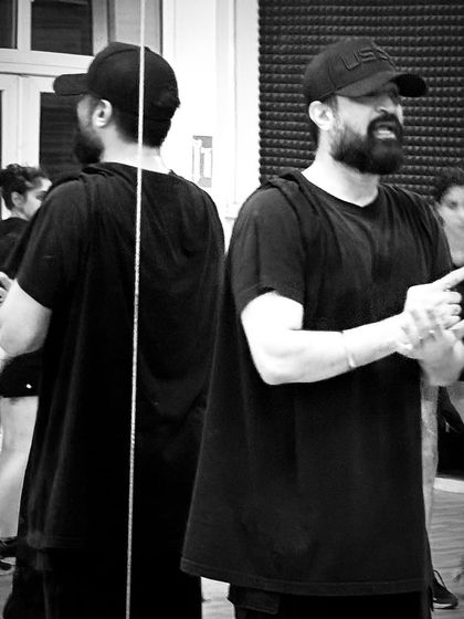 Another angle from a coaching session, showing my reflection in the mirror as I guide the dancers.