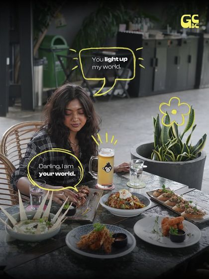 A table full of food and a couple enjoying a drink. This is what a perfect date night looks like.