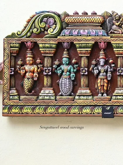 A detailed section of the exquisite wooden Dasavatharam panel. This close-up shows the first three avatars, Matsya, Kurma, and Varaha, each figure distinctly carved and vividly painted.