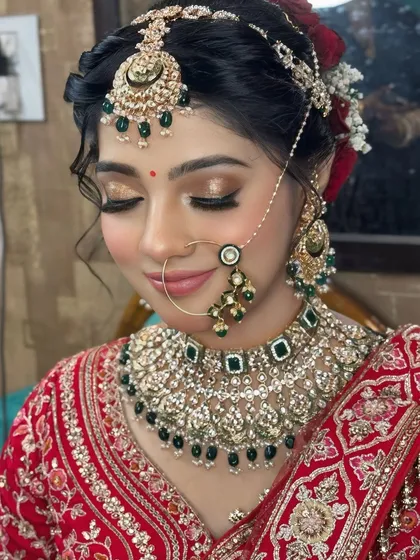 A detailed close-up of the bride's soft glam eye makeup, featuring golden glitter and winged liner, paired with a natural lip color.