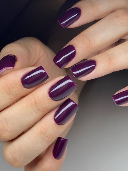 A rich, dark purple polish on perfectly shaped square nails. The glossy finish makes this bold color look incredibly luxurious.